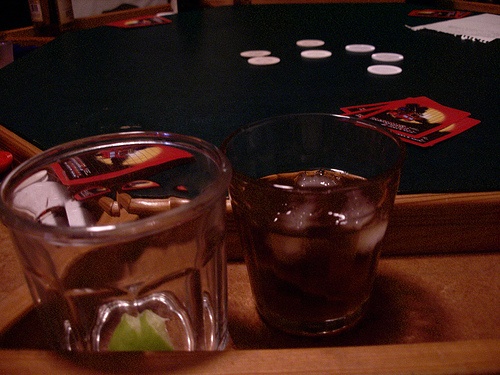 poker ante on table with whisky glass