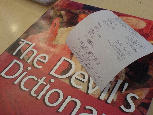 photo image of devil’s dictionary book plus bookstore receipt, with price at 666 (.66)